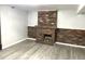 Cozy basement features a wood burning fireplace and neutral vinyl flooring at 1299 S Brentwood Way, Lakewood, CO 80232