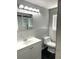 Bathroom features marble tiled walls, a modern vanity, and stylish lighting at 1299 S Brentwood Way, Lakewood, CO 80232