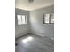 Bedroom with two windows for natural light and grey vinyl flooring at 1299 S Brentwood Way, Lakewood, CO 80232