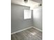 A well-lit bedroom featuring wood look vinyl flooring and neutral walls at 1299 S Brentwood Way, Lakewood, CO 80232