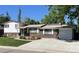 Charming brick home with a well-maintained front yard, driveway, and attached garage at 1299 S Brentwood Way, Lakewood, CO 80232