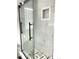Gorgeous tiled shower with glass doors and built-in niche shelving at 1299 S Brentwood Way, Lakewood, CO 80232