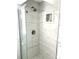 Bathroom showcases a glass shower, marble tile, and built-in storage at 1299 S Brentwood Way, Lakewood, CO 80232
