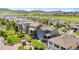 Wide aerial view showing a neighborhood of homes on a sunny day with a mountain backdrop at 18180 W 84Th Pl, Arvada, CO 80007