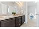 Bathroom featuring double sinks and dark cabinets at 18180 W 84Th Pl, Arvada, CO 80007