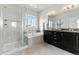 Bright bathroom featuring a double vanity, soaking tub, and separate glass enclosed shower at 18180 W 84Th Pl, Arvada, CO 80007