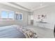 Bright bedroom featuring two windows, tray ceiling, artwork and soft carpet floors at 18180 W 84Th Pl, Arvada, CO 80007