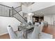 Open dining area with wood floors flows into kitchen, complemented by modern light fixture at 18180 W 84Th Pl, Arvada, CO 80007