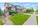 A lush green lawn and mature landscaping enhance the curb appeal of this charming home at 18180 W 84Th Pl, Arvada, CO 80007