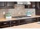 The kitchen has granite countertops, a stone backsplash, and a gas range at 18180 W 84Th Pl, Arvada, CO 80007