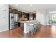 Spacious kitchen island with seating and stainless steel refrigerator at 18180 W 84Th Pl, Arvada, CO 80007