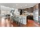 Stunning kitchen features dark cabinets, granite countertops, and stainless steel appliances at 18180 W 84Th Pl, Arvada, CO 80007