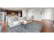 Inviting living room with hardwood floors, an open kitchen, and a cozy seating arrangement at 18180 W 84Th Pl, Arvada, CO 80007