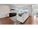 Contemporary living room with a large sofa, stylish decor, and lots of natural light at 18180 W 84Th Pl, Arvada, CO 80007