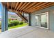 Covered patio area with concrete flooring and sliding glass doors, ideal for outdoor entertaining and relaxation at 18180 W 84Th Pl, Arvada, CO 80007