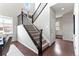 Carpeted staircase with dark wood railing and white walls leads to the upper level of the home at 18180 W 84Th Pl, Arvada, CO 80007