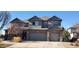 Two-story home with a three-car garage, gray siding, and brick accents at 14137 Whitney Cir, Broomfield, CO 80023