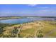 Expansive aerial view of community featuring a large lake and cityscape in the distance at 13762 E Lehigh Ave # G, Aurora, CO 80014