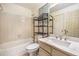 Bathroom with a combined tub and shower, and a vanity with a marble countertop, offering functional space at 13762 E Lehigh Ave # G, Aurora, CO 80014