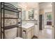 Bathroom with decorative shelving, updated sink, and unique wallpaper at 13762 E Lehigh Ave # G, Aurora, CO 80014