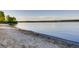 Peaceful beach scene with calm water and sandy shoreline at 13762 E Lehigh Ave # G, Aurora, CO 80014