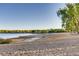 Tranquil beach scene with a shoreline meeting a calm lake and a tree shading a sandy shore at 13762 E Lehigh Ave # G, Aurora, CO 80014