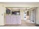 Open kitchen area with dark cabinets, stainless steel refrigerator, and a counter overlooking the living space at 13762 E Lehigh Ave # G, Aurora, CO 80014
