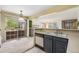 Open kitchen with appliances and sliding glass door at 13762 E Lehigh Ave # G, Aurora, CO 80014