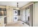 Convenient laundry area situated off of the kitchen, featuring a stacked washer and dryer set at 13762 E Lehigh Ave # G, Aurora, CO 80014