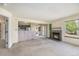 Open-concept living room featuring a fireplace and a view into the adjacent dining area at 13762 E Lehigh Ave # G, Aurora, CO 80014