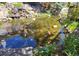Backyard pond with decorative rocks, waterfall feature, and koi fish at 13762 E Lehigh Ave # G, Aurora, CO 80014