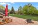 Outdoor patio with a fire pit and a picnic table overlooking the lawn at 21684 Swale Ave, Parker, CO 80138