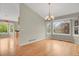 A dining room with hardwood floors, bay windows, and a chandelier at 21684 Swale Ave, Parker, CO 80138