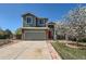 Charming two-story home featuring a front porch, red front door, and a manicured lawn at 21684 Swale Ave, Parker, CO 80138
