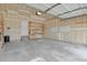 Unfinished two-car garage with shelving and a back door at 21684 Swale Ave, Parker, CO 80138