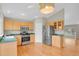 A kitchen with stainless steel appliances, wood cabinets, and a door to the backyard at 21684 Swale Ave, Parker, CO 80138