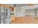 Kitchen with stainless steel fridge, wood cabinets, and view to living room at 21684 Swale Ave, Parker, CO 80138