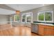 A kitchen with stainless steel sink, wood cabinets, and view to backyard at 21684 Swale Ave, Parker, CO 80138