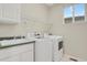 A laundry room with a sink, washer, dryer, and overhead storage at 21684 Swale Ave, Parker, CO 80138