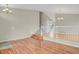 Open-concept living area with hardwood floors, white banisters, and staircase, creating a spacious feel at 21684 Swale Ave, Parker, CO 80138