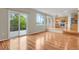 A living room with hardwood floors, sliding glass doors, and a view to the kitchen at 21684 Swale Ave, Parker, CO 80138