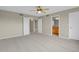 Spacious bedroom with ceiling fan, closet, and doorway views to the bathroom at 21684 Swale Ave, Parker, CO 80138