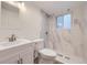 Modern bathroom featuring stylish fixtures and walk-in shower with unique marble design at 845 S 9Th Ave, Brighton, CO 80601