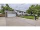 A ranch style home with a 2-car garage and a long driveway surrounded by a lush lawn at 845 S 9Th Ave, Brighton, CO 80601