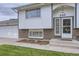 Close up of the entrance of a charming two-story home with an attached garage at 845 S 9Th Ave, Brighton, CO 80601