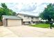 Lovely home with an attached garage and a lush green lawn, perfect for suburban living at 845 S 9Th Ave, Brighton, CO 80601