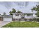 Charming two-story home features a well-manicured front lawn and an attached garage at 845 S 9Th Ave, Brighton, CO 80601