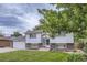 Charming split-level home featuring a well-manicured lawn and brick accents on the facade at 845 S 9Th Ave, Brighton, CO 80601