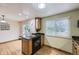 Modern kitchen featuring granite countertops, stainless steel appliances, and access to the dining area at 845 S 9Th Ave, Brighton, CO 80601