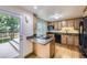 Modern kitchen featuring granite countertops, stainless steel appliances, and access to the outdoor deck at 845 S 9Th Ave, Brighton, CO 80601